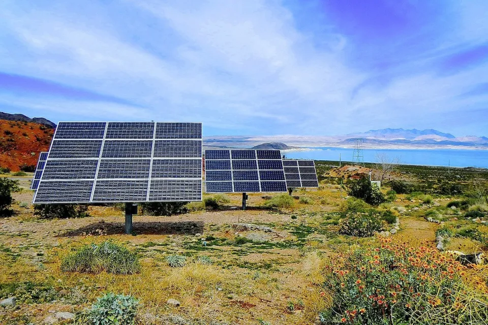Solar panels installed ona hillside with Lake Mead, Nevada in background.